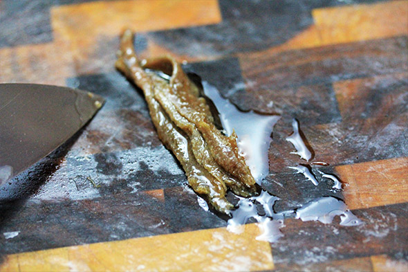 chop up about 3 small anchovy filets, really finely until they're like a paste.